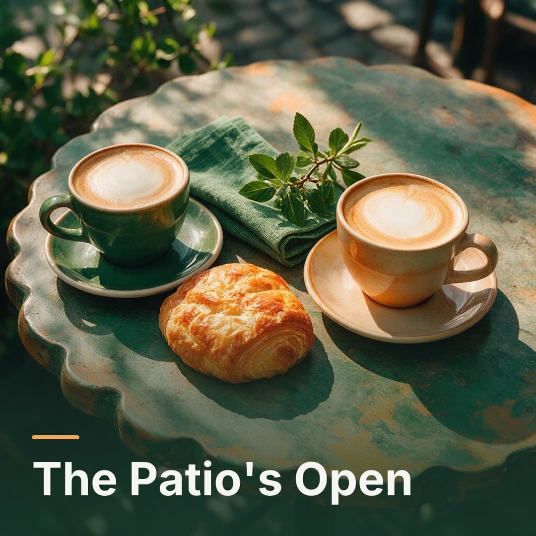 Two flat whites and a pastry on a patio table